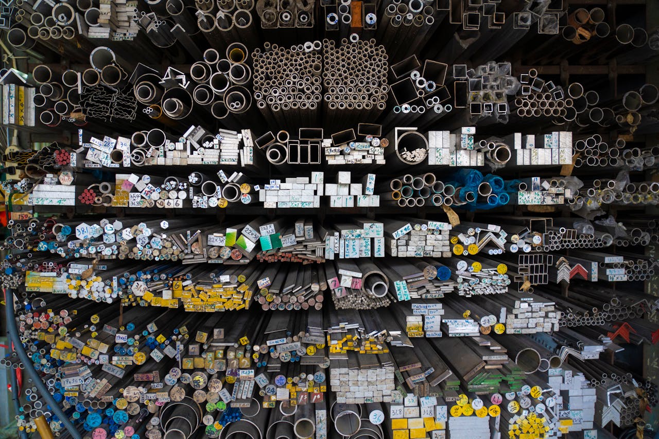 The Art of Drawing Readers In: Your attractive post title goes here Diverse collection of stacked metallic pipes and rods in a warehouse display.